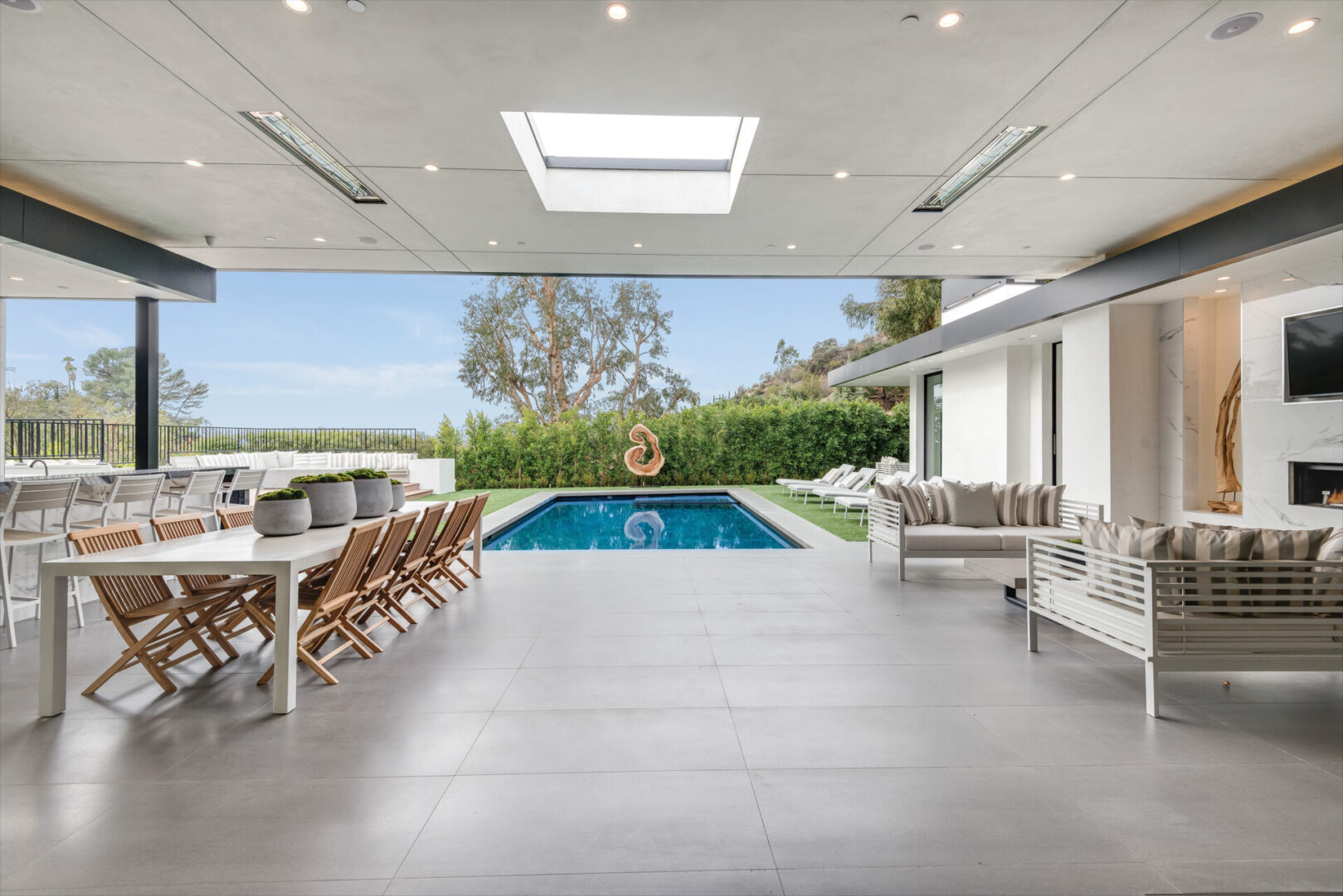 A large open patio with a pool and outdoor furniture.